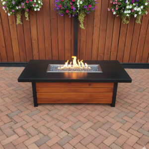concrete and wood outdoor fire feature glowing at dusk