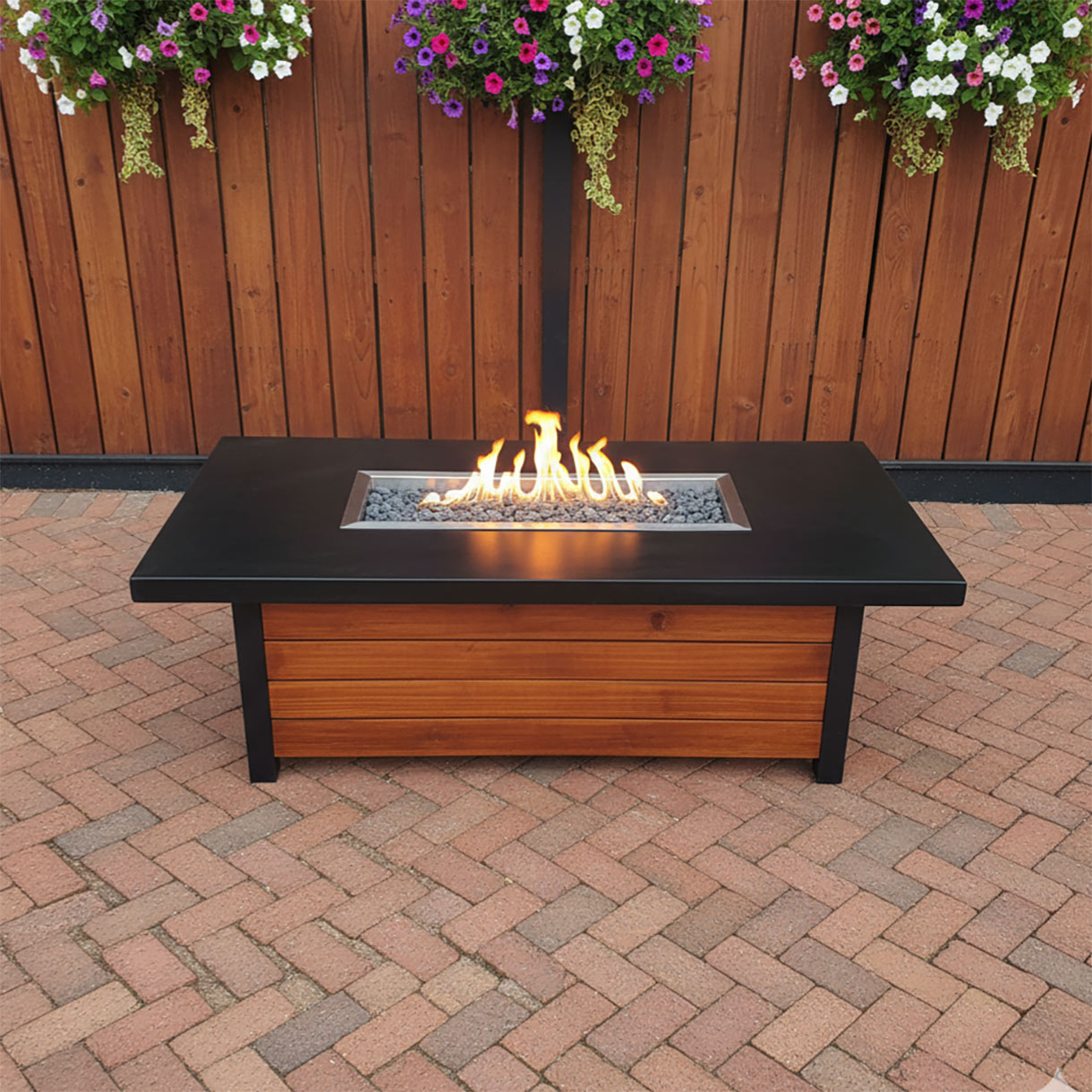 concrete and wood outdoor fire feature glowing at dusk
