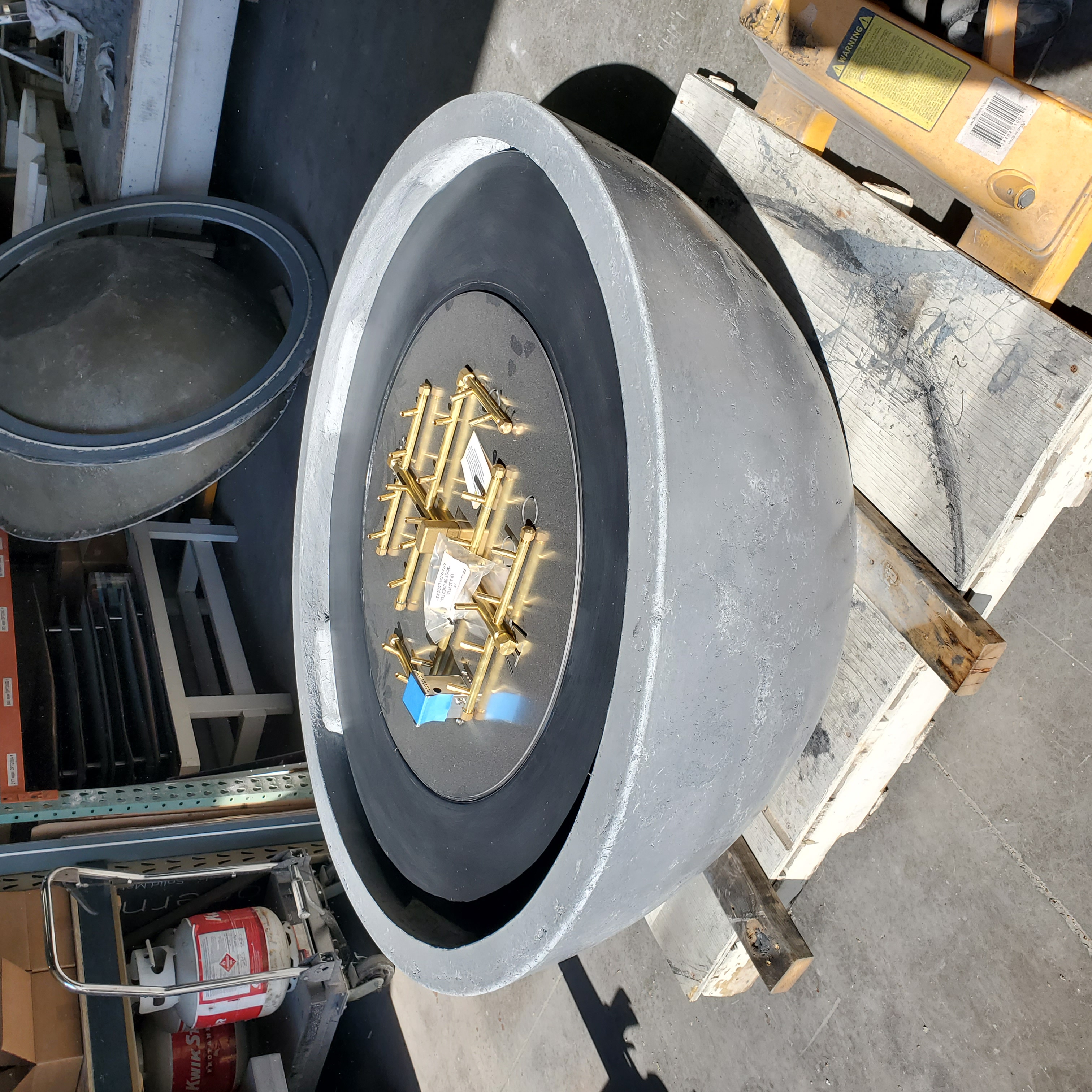 52-inch Zen Fire Bowl with Warming Trends Crossfire brass burner assembly laid out inside, ready to ship – CastinCrete studio, Hartland WI